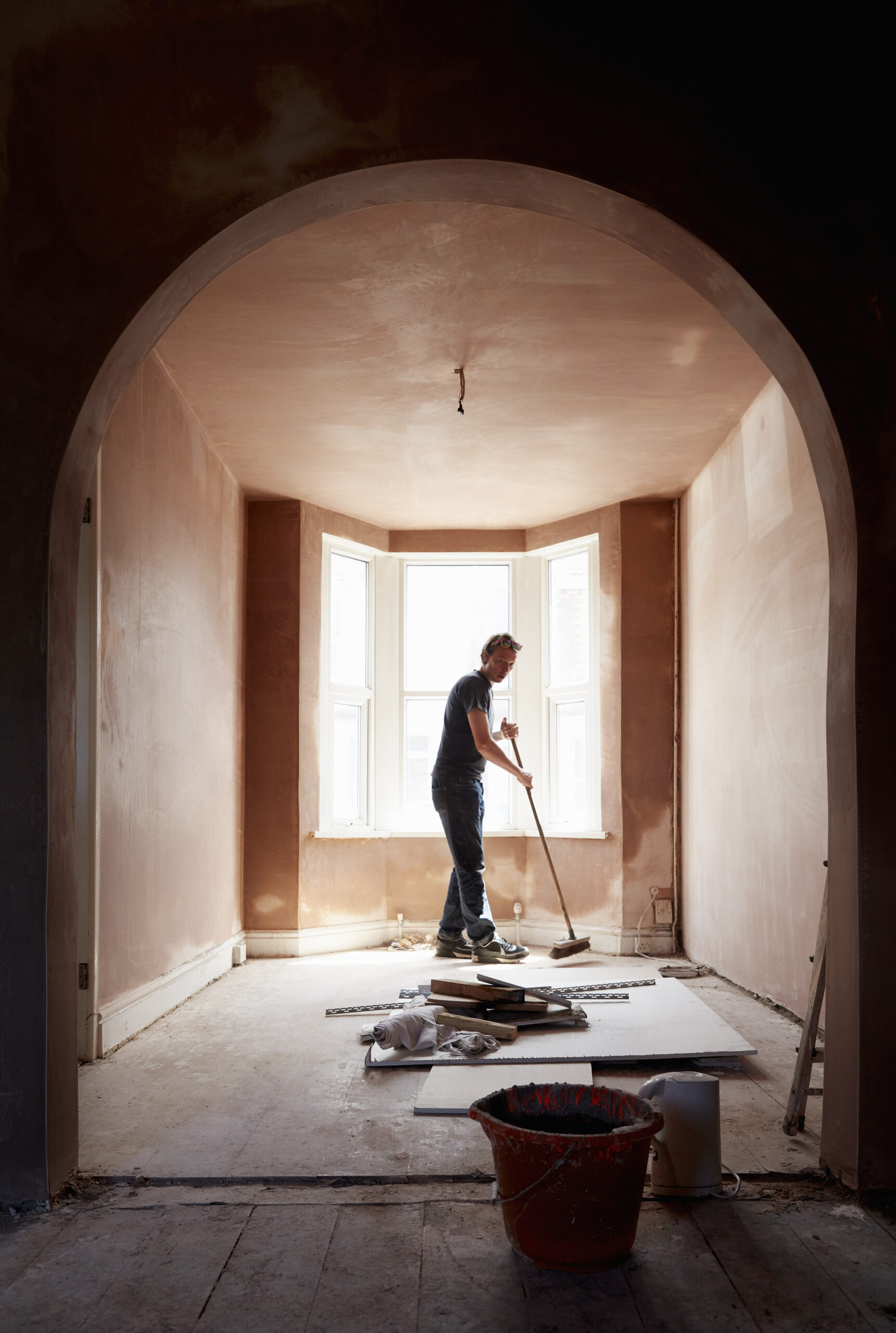 A Builder Sweeping And Tidying Up In A Renovated R 2026 01 09 08 35 41 Utc